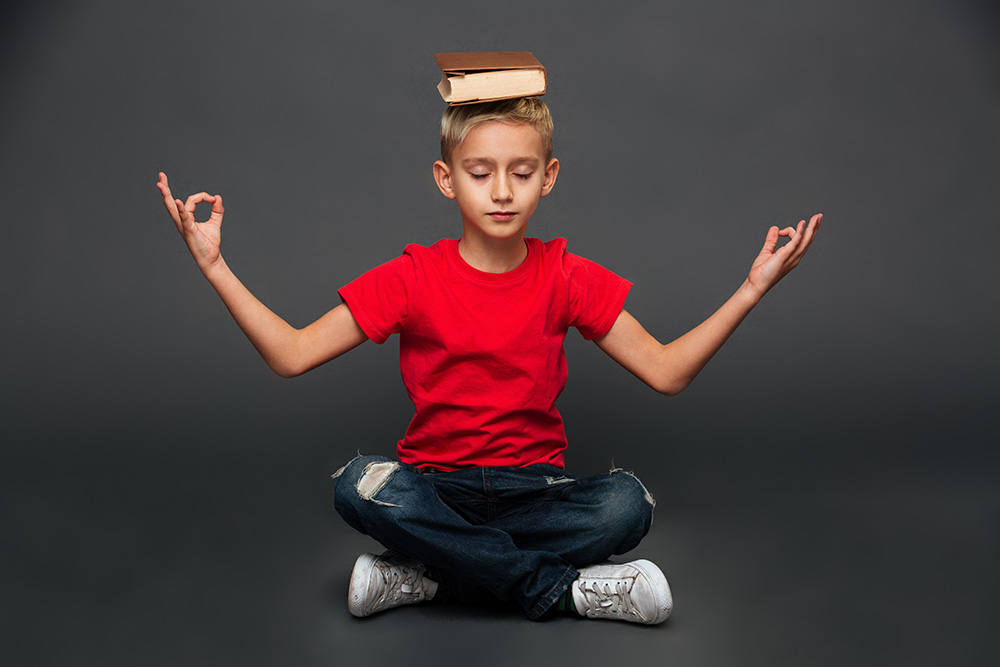 little boy child meditate with book head new