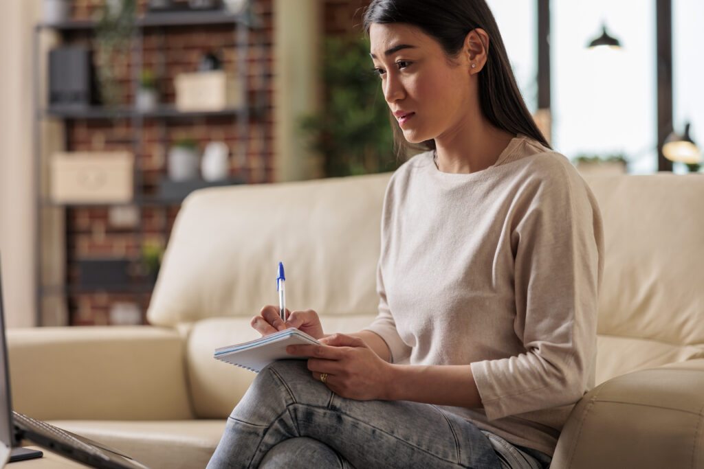 asian woman taking notes distance e learning online training classes student webinar education home office smart university job application chat talking training remote study work from home