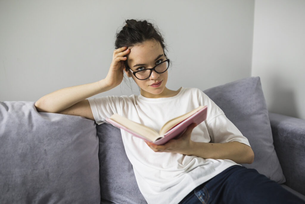 pretty woman with book looking camera